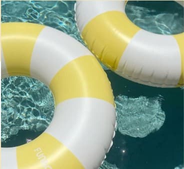 Yellow and white pool rings floating in water